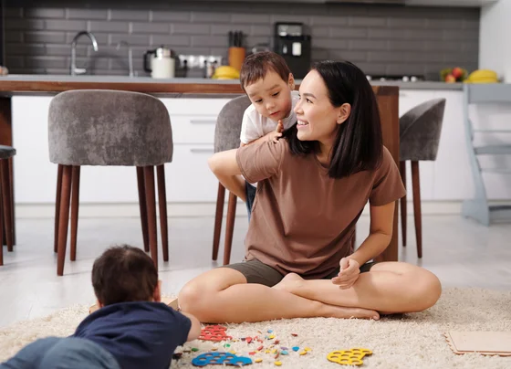 A parent and child playing together in a cozy living room
